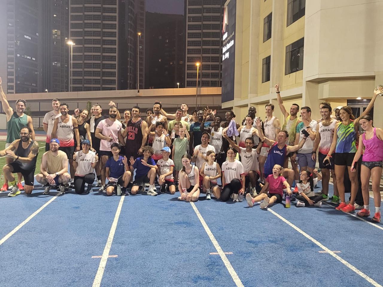 Club group photo on the track at night